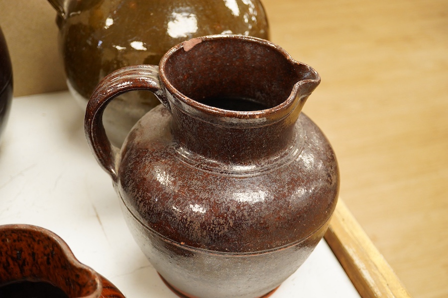 A group of stoneware glazed flagons and jugs, largest 29cm high. Condition - some chips